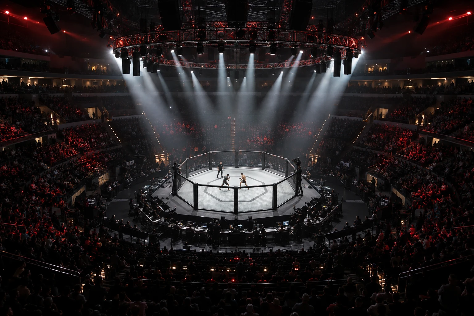 A floodlit MMA cage surrounded by a dark arena